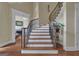 Elegant staircase with hardwood steps, a decorative iron railing, and wood accents, adding a touch of sophistication at 185 Platinum Ridge Pt, Fayetteville, GA 30215