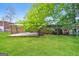 Backyard with a well maintained lawn, patio, brick home and trees in the background at 2282 Belmont Dr, Decatur, GA 30032