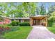 Charming single-story home with a brick facade, mature trees, and a covered carport at 2282 Belmont Dr, Decatur, GA 30032