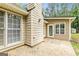 The back of the home features neutral siding, double-pane windows, and a concrete patio at 215 Longwood Dr, Jonesboro, GA 30236