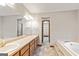 This bathroom features a bathtub and a vanity with double sinks at 215 Longwood Dr, Jonesboro, GA 30236