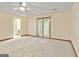 This carpeted bedroom includes french doors and a ceiling fan at 215 Longwood Dr, Jonesboro, GA 30236