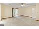 This carpeted bedroom includes a ceiling fan and a doorway leading to another room at 215 Longwood Dr, Jonesboro, GA 30236