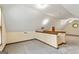 Bonus room with neutral carpeting, sloped ceiling, half wall, and staircase at 215 Longwood Dr, Jonesboro, GA 30236