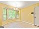 Eat-in kitchen area featuring a chandelier and bay window with natural light at 215 Longwood Dr, Jonesboro, GA 30236