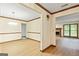 A dining room featuring wood flooring and trim and a view of the fireplace in the living room at 215 Longwood Dr, Jonesboro, GA 30236
