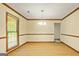 Spacious dining room with wood floors, decorative crown molding and natural light from a window at 215 Longwood Dr, Jonesboro, GA 30236