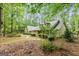 Secluded two-story home with brick accents and mature trees on a large wooded lot at 215 Longwood Dr, Jonesboro, GA 30236