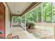 A covered front porch featuring white railings and columns offers a shaded spot to relax at 215 Longwood Dr, Jonesboro, GA 30236