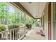 The welcoming front porch provides a perfect spot to enjoy the serene surroundings and curb appeal at 215 Longwood Dr, Jonesboro, GA 30236