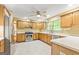 Well-lit kitchen features wood cabinets, stainless steel appliances, and tiled floors at 215 Longwood Dr, Jonesboro, GA 30236
