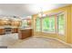 Eat-in kitchen featuring a chandelier, bay window, stainless steel appliances, and tiled flooring at 215 Longwood Dr, Jonesboro, GA 30236