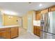 The bright, warm kitchen is open to the eat-in kitchen with stainless steel refrigerator at 215 Longwood Dr, Jonesboro, GA 30236