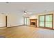 The living room features a brick fireplace, wood floors, and double doors to the back patio at 215 Longwood Dr, Jonesboro, GA 30236