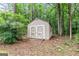 A storage shed with white cross-buck doors adds practical space and style to the property at 215 Longwood Dr, Jonesboro, GA 30236