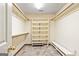 Spacious walk-in closet with built-in shelves, rods, and bench seating at 215 Longwood Dr, Jonesboro, GA 30236