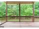 Spacious back porch with a wood railing and a view of the lush green backyard at 5130 Pratt Sw St, Covington, GA 30014