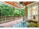 Inviting covered back porch with a wood ceiling, brick columns, and views of the lush backyard at 5130 Pratt Sw St, Covington, GA 30014