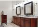 Bathroom featuring double sinks, dark cabinetry, and granite countertops at 5130 Pratt Sw St, Covington, GA 30014