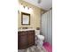 Bathroom with a vanity, toilet, mirror, and shower with textured wall tiles at 5130 Pratt Sw St, Covington, GA 30014