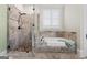 Bright bathroom with a tub and shower combo, stone accents, and natural light at 5130 Pratt Sw St, Covington, GA 30014