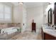 Bathroom features a tub with stone accents, double sinks, and granite countertops at 5130 Pratt Sw St, Covington, GA 30014