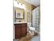 Bathroom with vanity, toilet, mirror, and shower featuring a floral patterned shower curtain at 5130 Pratt Sw St, Covington, GA 30014