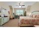 Sunny bedroom featuring a comfortable bed, desk area, and a ceiling fan at 5130 Pratt Sw St, Covington, GA 30014