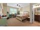 Bright bedroom showcasing a desk area, a ceiling fan, and an en-suite bathroom at 5130 Pratt Sw St, Covington, GA 30014