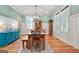 Charming dining room features an elegant light fixture and beautiful wood floors at 5130 Pratt Sw St, Covington, GA 30014