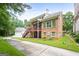 Brick home with multi-level deck, attached garage and lush landscaping at 5130 Pratt Sw St, Covington, GA 30014