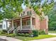 Charming brick home with a spacious front porch and lush landscaping at 5130 Pratt Sw St, Covington, GA 30014