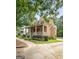 Brick home featuring a welcoming front porch and side driveway at 5130 Pratt Sw St, Covington, GA 30014