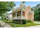 Side view of brick home with a welcoming front porch and beautiful yard at 5130 Pratt Sw St, Covington, GA 30014
