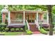 Brick home featuring an inviting front porch with mature landscaping at 5130 Pratt Sw St, Covington, GA 30014