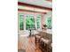 Eat-in kitchen with wood floors, stone countertops, large windows, and wooden beams at 5130 Pratt Sw St, Covington, GA 30014