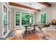Eat-in kitchen with wood floors, breakfast table, large windows, and wooden beams at 5130 Pratt Sw St, Covington, GA 30014