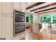 Bright kitchen with island, stainless oven, and wood beam ceiling at 5130 Pratt Sw St, Covington, GA 30014