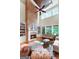 Large living room boasts tall windows, brick fireplace, and custom built-in shelving at 5130 Pratt Sw St, Covington, GA 30014