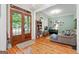 Cozy living room with double doors, hardwood floors, and a comfortable sofa at 5130 Pratt Sw St, Covington, GA 30014