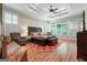 Spacious main bedroom with tray ceiling, ceiling fan and hardwood floors at 5130 Pratt Sw St, Covington, GA 30014