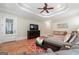 Spacious main bedroom features tray ceilings, TV, and hardwood floors at 5130 Pratt Sw St, Covington, GA 30014