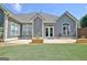 Home exterior with manicured lawn, french doors, and an arched window at 260 Bonnie Ln, Fayetteville, GA 30215