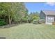 View of a backyard with a manicured lawn and mature landscaping, including trees at 260 Bonnie Ln, Fayetteville, GA 30215