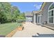 Exterior patio featuring french doors and grass with flower pots lining the edge at 260 Bonnie Ln, Fayetteville, GA 30215