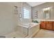 Bathroom featuring separate shower, soaking tub, and tile surround at 260 Bonnie Ln, Fayetteville, GA 30215