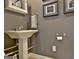 Powder room with a pedestal sink, towel bar, and framed artwork at 260 Bonnie Ln, Fayetteville, GA 30215