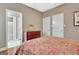 Bedroom with a neutral color palette, hardwood floors, and access to a bathroom at 260 Bonnie Ln, Fayetteville, GA 30215