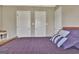 Bedroom featuring a bed with white door closets on the wall at 260 Bonnie Ln, Fayetteville, GA 30215