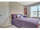 Cozy bedroom with neutral walls, natural light, and a purple comforter at 260 Bonnie Ln, Fayetteville, GA 30215